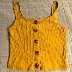 It’s a orange tank top small. It’s also a little cropped with buttons.